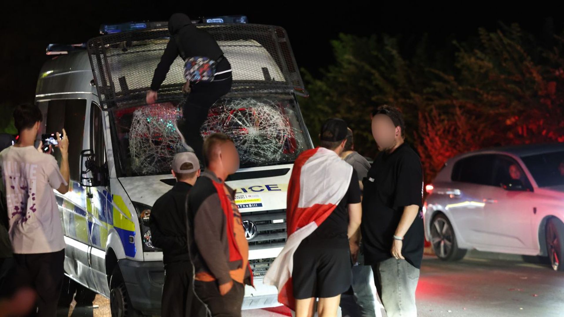 Eight police officers injured in clash with protesters outside alleged asylum seeker hotel
