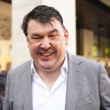 Father Ted co-creator arrives for trial charged with harassing transgender activist
