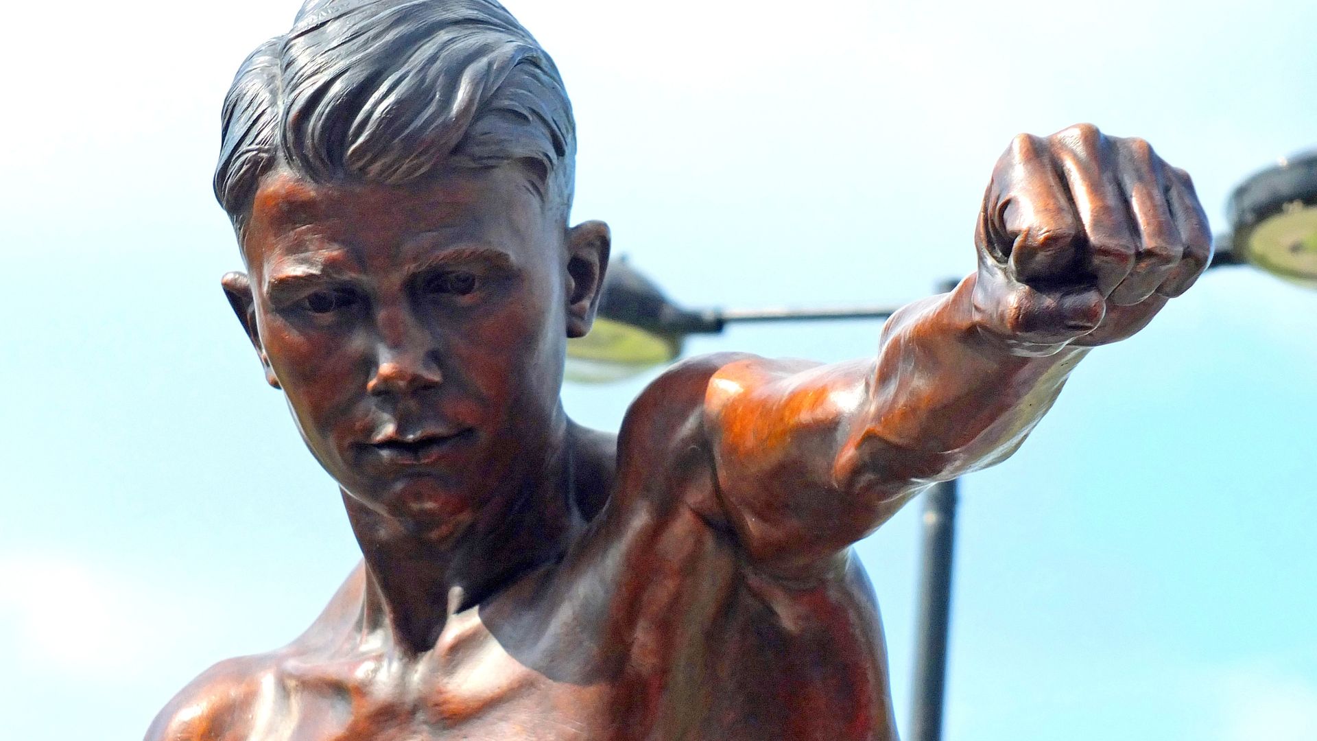Masked thieves steal statue of local hero boxer using three-wheel bike and hi-vis jacket