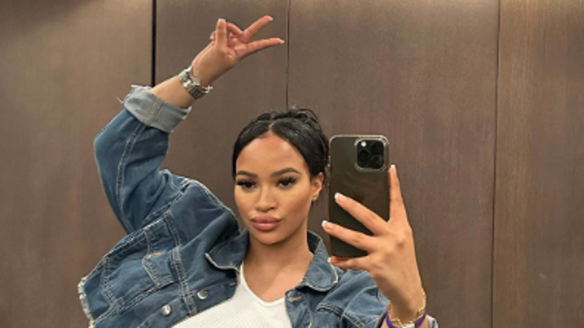 X Factor finalist accused of attempted murder makes heart sign from dock