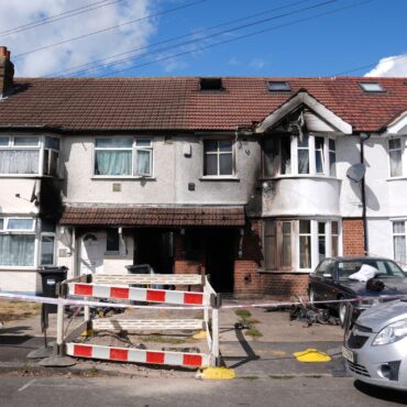 Man arrested on suspicion of murder after house fire kills one and injures eight